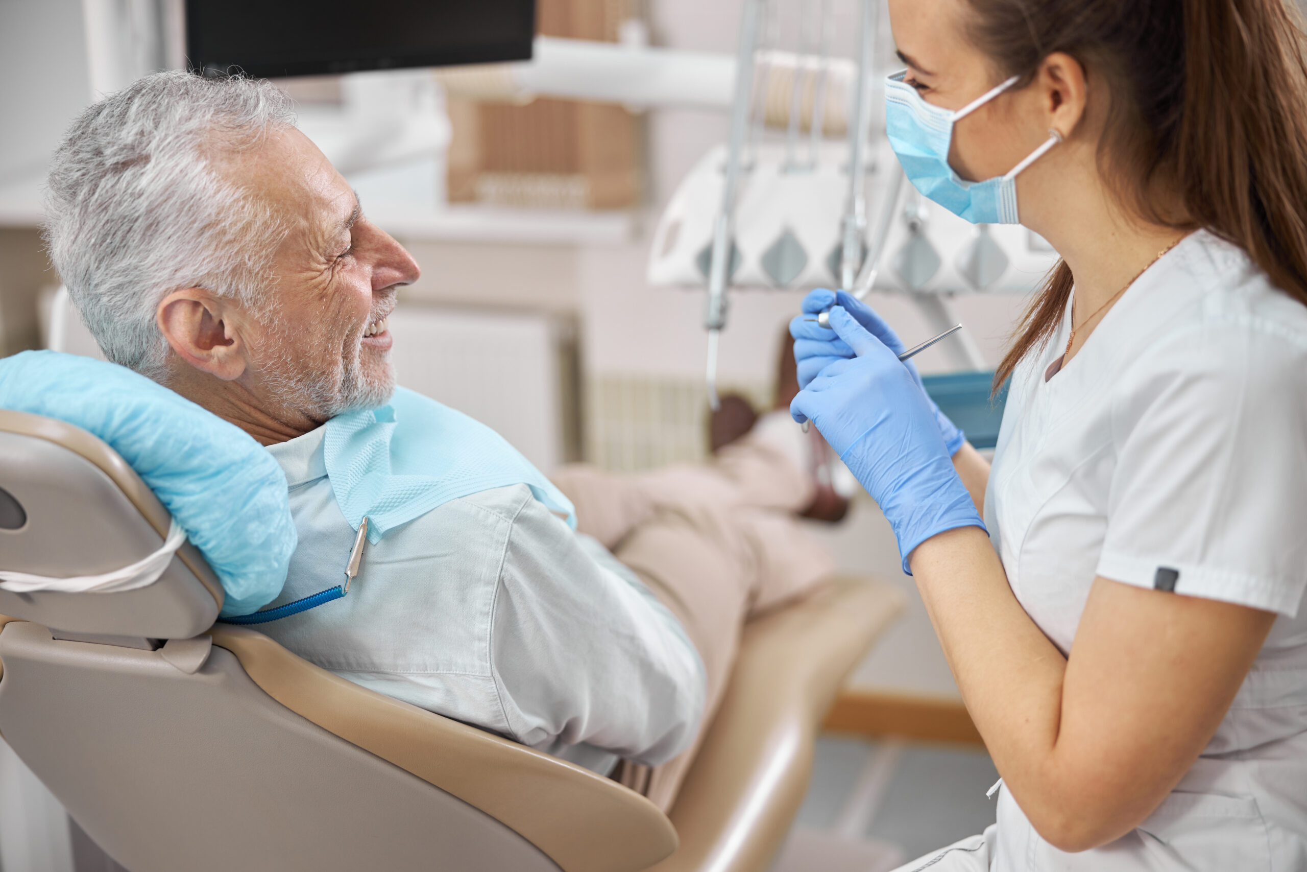 Optimistic,Senior,Citizen,Smiling,At,His,Joyful,Female,Dentist,During